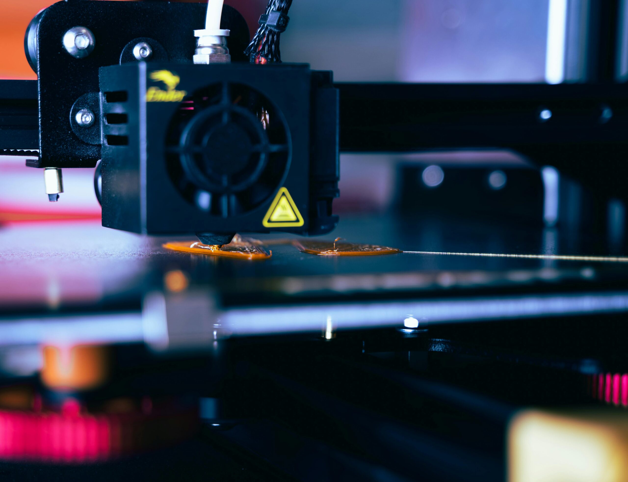 Detailed view of a 3D printer head during operation, showcasing modern printing technology.